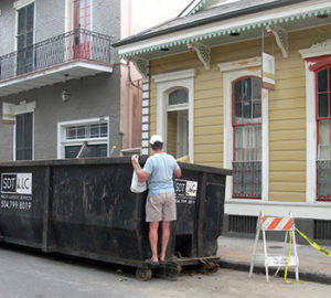 Man looking into dumpster