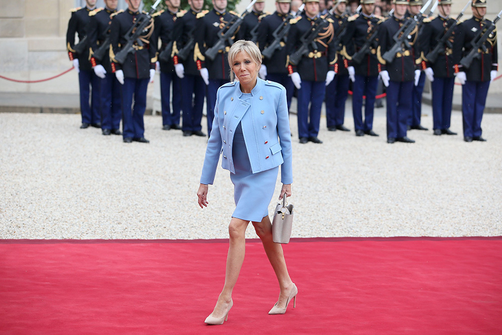 Brigitte Macron Wears Skinny Jeans & Louis Vuitton Run Away